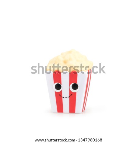 Children's cute toy food popcorn with a smile on a white background