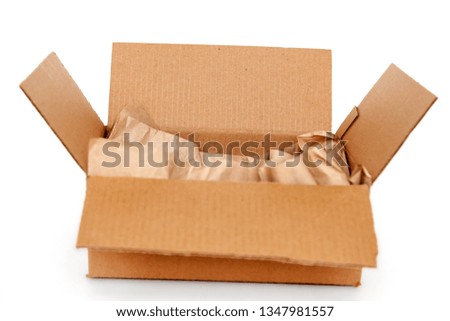 Cardboard box with wrapping paper inside isolated on white background, recycling concept