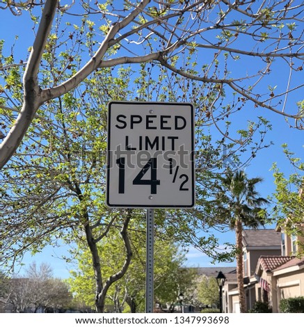 View of speed limit sign in private community hoa - limit is 14 1/2 miles per hour
