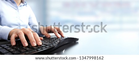 Hands typing keyboard.