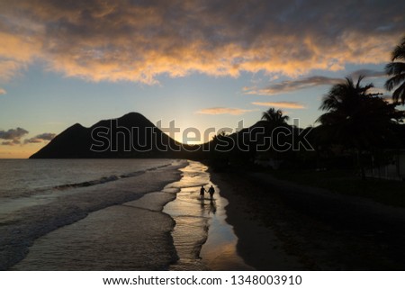 Scenic landscape view over the Diamond beach under a colorful and cloudy sunset, Martinique, West Indies.