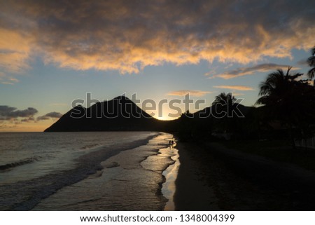Scenic landscape view over the Diamond beach under a colorful and cloudy sunset, Martinique, West Indies.