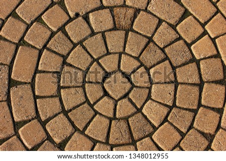 Stone pavement in perspective. Stone pavement texture. Granite cobblestoned pavement background. Abstract background of a cobblestone pavement close-up Royalty-Free Stock Photo #1348012955