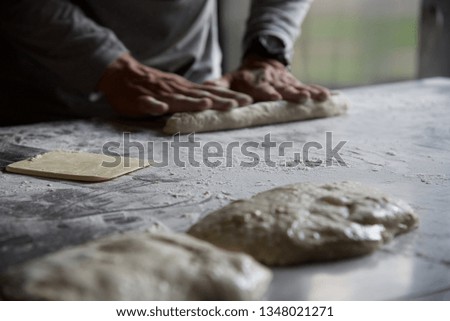 Bread making: in a restaurant kitchen the chef sets about making traditional French baguettes called Ficelle — the French word for string.