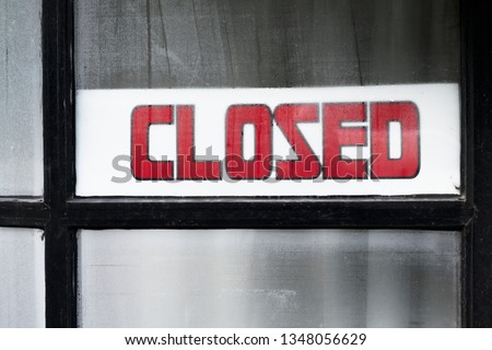 Closed sign on shop window door