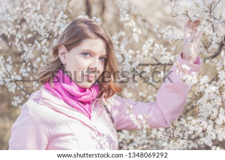 Female posing, spring background with flowers