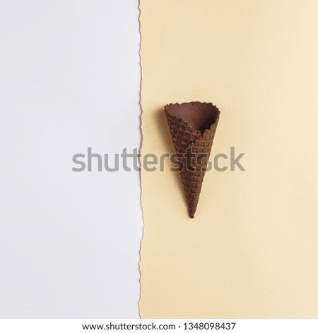 Waffle cone for ice cream on a paper background. Top view. Copy space. Minimalistic concept.