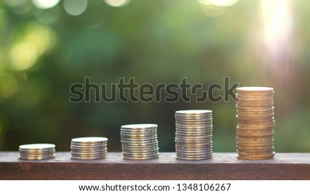 Money coin stack on wood with blur background. Saving money concept.  economic growth. finance sustainable development.