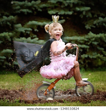 Princess little girl playing in mud