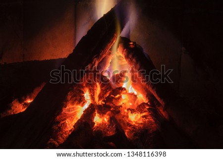 Close up shot of burning firewood in the fireplace to mean a concept