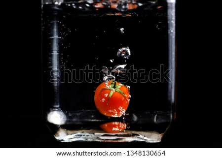 Cherry tomato. Fresh cherry tomato dropped into the water.