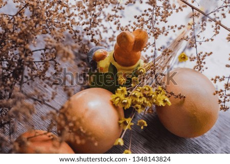 Easter bunny with basket and giant eggs. Beautiful composition of eggs and rabbits.