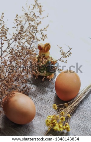 Easter bunny with basket and giant eggs. Beautiful composition of eggs and rabbits.