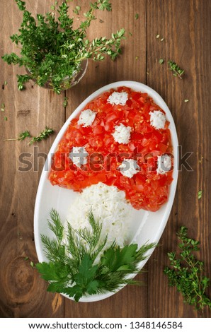 Layered salad in the shape of a mushroom. Decoration is made of eggs and tomatoes