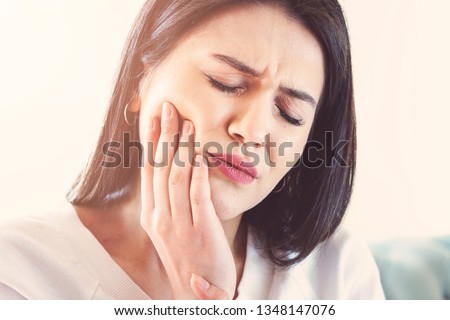 Woman suffering from toothache, tooth decay or sensitivity. Royalty-Free Stock Photo #1348147076