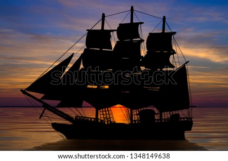 Old ancient pirate ship silhouette on peaceful ocean at sunset background