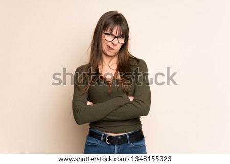 Young woman on ocher background feeling upset