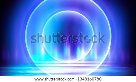 Neon circle, neon lights. Neon circle with spotlights. Abstract light. Night view. Blue abstract background with rays and lines.