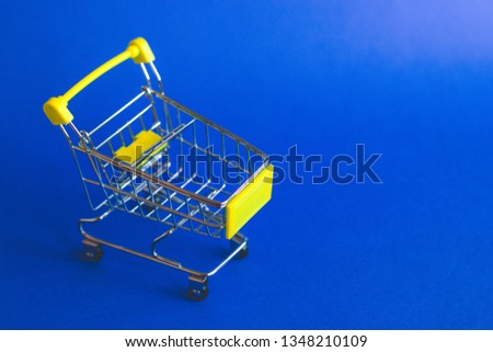Empty shopping basket on blue background