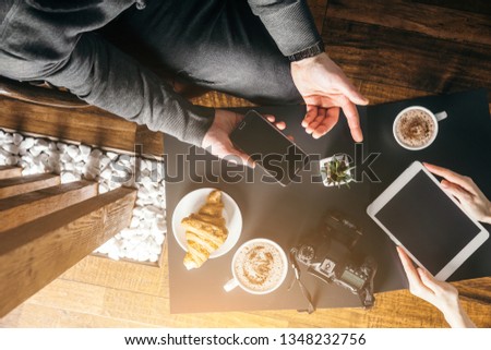 Young man in morning cafe drink coffee and read daily news