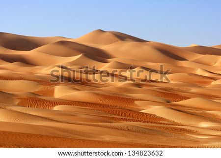 A dune landscape in the Rub al Khali or Empty Quarter. Straddling Oman, Saudi Arabia, the UAE and Yemen, this is the largest sand desert in the world. Royalty-Free Stock Photo #134823632