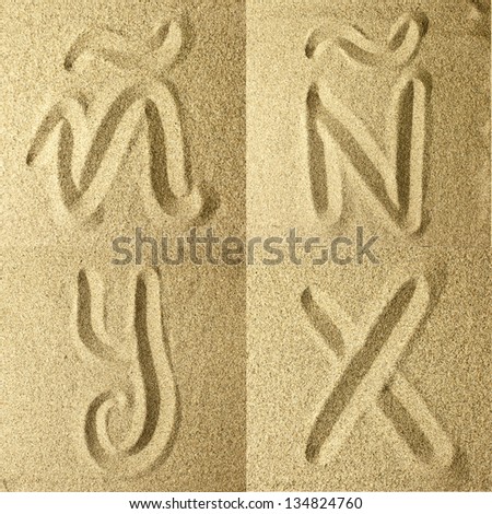 letter y,x,Ã?Â± handwritten in the sand
