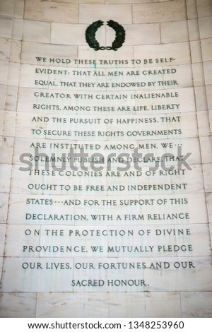 Pursuit of happiness inscription excerpted from the Declaration of Independence carved in white marble on the curved rotunda wall of the Thomas Jefferson Memorial in Washington DC, USA