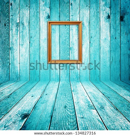 Picture frame on blue wood background