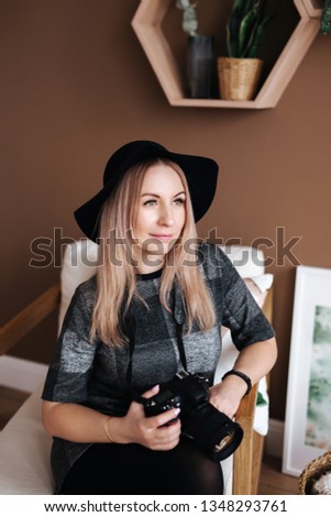 portrait of young beautiful stylish woman with camera. Cheerful female vlogger with camera