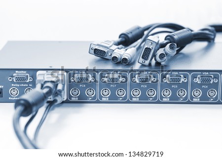 KVM (keyboard, video and mouse) switch and network cables, blue coloration Royalty-Free Stock Photo #134829719