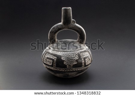 Pre-columbian ceramic called "Huaco" from Chimu, an ancient Peruvian culture. Pre inca handcrafted pottery piece made by this ancient civilization. Royalty-Free Stock Photo #1348318832