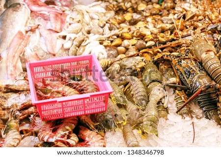 Seafood on ice at the fish market. Lobster, shrimps, mussels and fish on counter of bazaar.