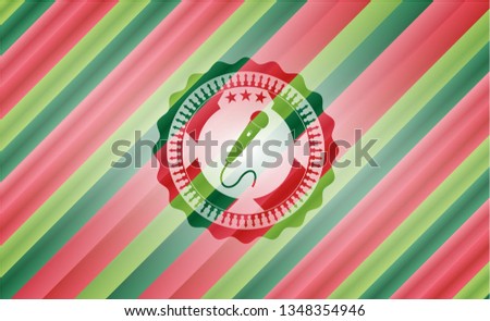 microphone icon inside christmas colors style badge.