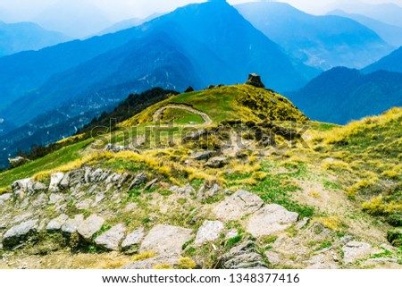 This is the view enroute to Khalia top trek trail through Himalayas autumn alpine grass landscape at Munsiyari. Khalia top is at an altitude of 3500m himalayan region of Kumaon, Uttarakhand, India. Royalty-Free Stock Photo #1348377416