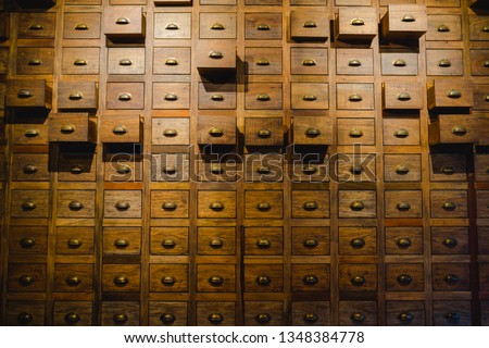 Old wooden textured drawers background in chinese herbal medicine shop in china.Vintage asian objects.  Royalty-Free Stock Photo #1348384778