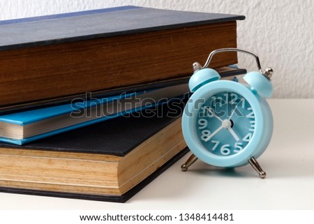 Education workspace background concepts. Books and an alarm clock. On a white background.         