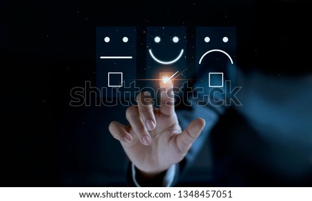 Finger of businessman touching and check mark icon face emoticon smile on dark background, service mind, service rating. Satisfaction and customer service concept Royalty-Free Stock Photo #1348457051