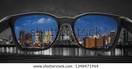 Looking through glasses to city at night. Color blindness glasses, Smart glass technology