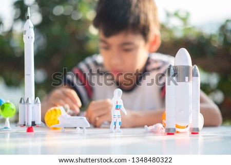 Little boy playing space ship and planet galaxy toy 
