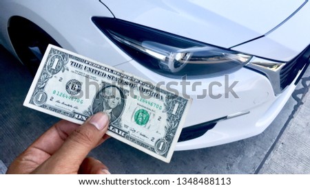 Dollar for everyday shopping, One dollar and car parked on background, Money of America.