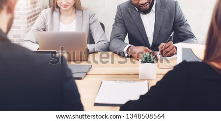Business people working together, using laptop and writing notes in office, crop