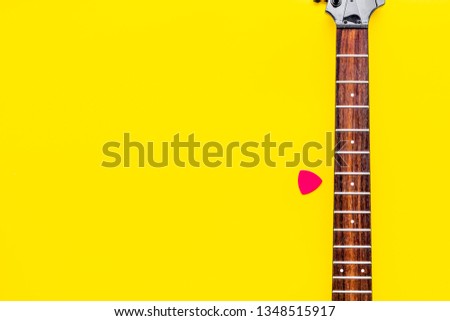 Musician work place with guitar on yellow background top view mock up