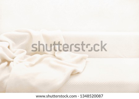 Sofa with white plaid. Selective focus.