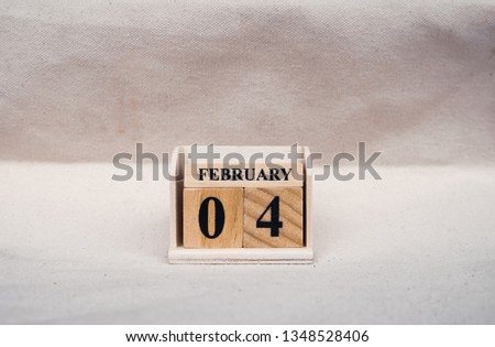 February 4th. Image of February 4 wooden color calendar  on white canvas background. empty space for text