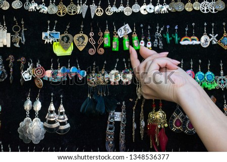 Many colorful earrings for sale at outside street market