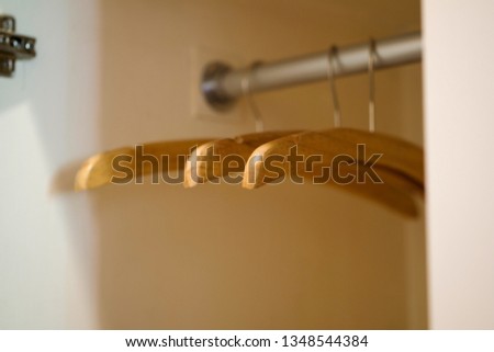 Wood empty hangers in house or hotel wardrobe