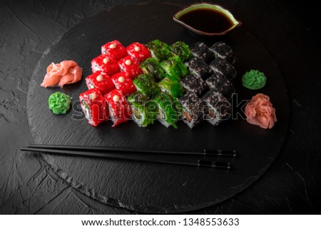 Sushi set of Philadelphia, California with fresh ingredients on black background. Sushi menu. Japanese food. 