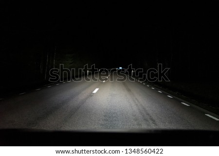 auxiliary lamps lighting up the dark road Royalty-Free Stock Photo #1348560422