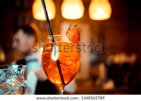 glasses of cocktails on the bar. bartender pours a glass of sparkling wine with Aperol.