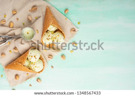 Ice cream with pistachios on a light background, with space. Summer mood
